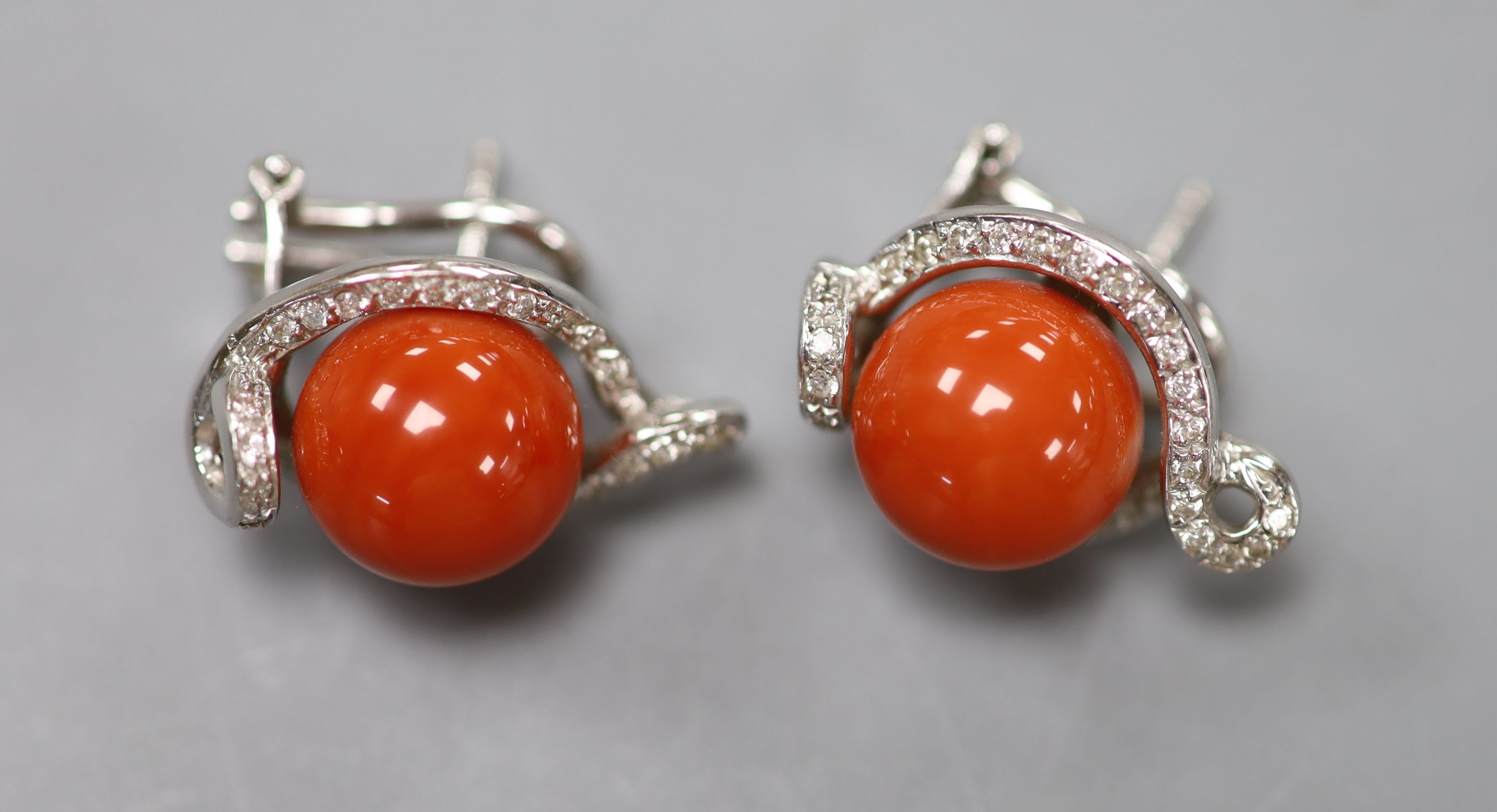 A modern pair of Italian 750 white metal, coral and diamond set earrings, 22mm, gross weight 13.2 grams.